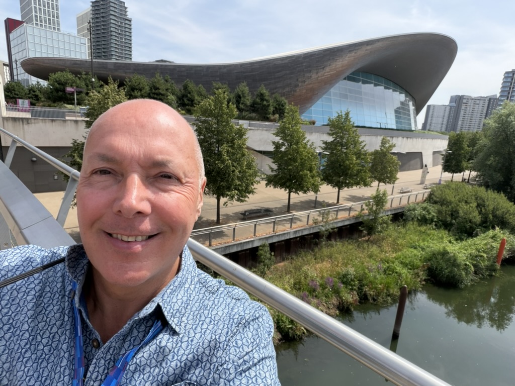 Mark on a bridge in front of the London Aquatics Centre